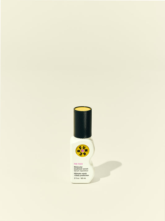Front solo packshot of The Fixer bottle against a beige background