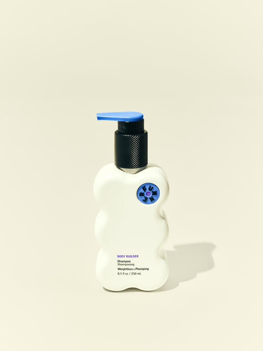 Front solo packshot of Body Builder 8.5 oz bottle against a beige background