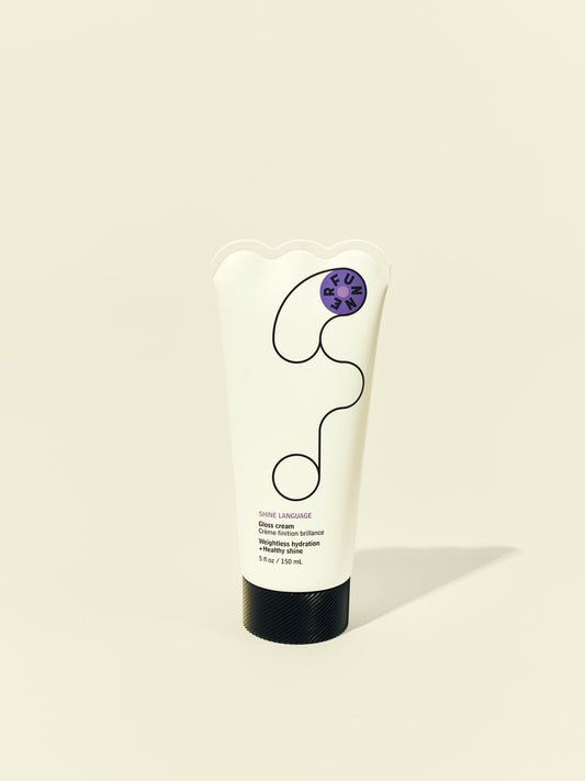 Front solo packshot of Shine Language tube against a beige background