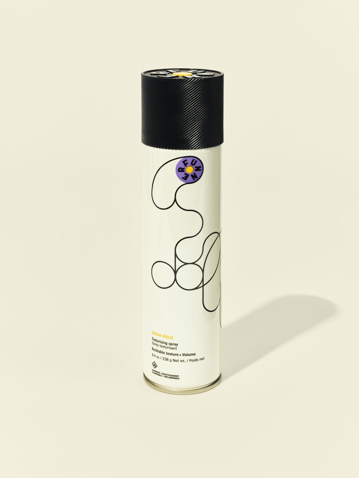Front solo packshot of Dream Build aerosol against a beige background