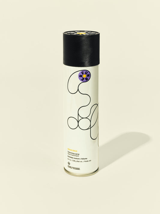 Front solo packshot of Dream Build aerosol against a beige background